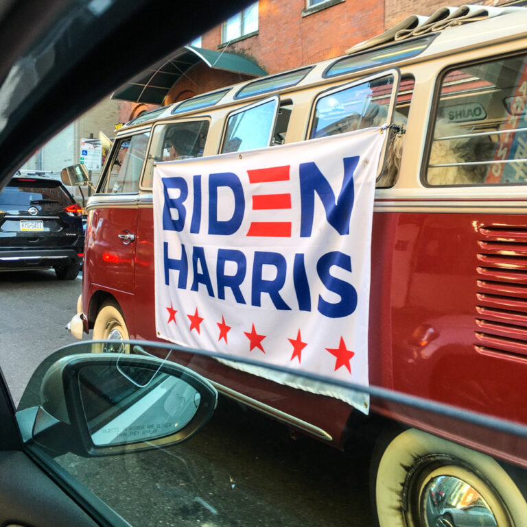 Minibus with a Biden Harris sign